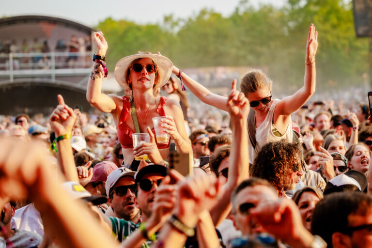 generic festival photo with women on shoulders over crowd